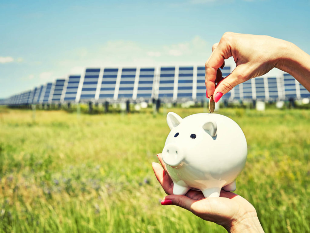 woman putting money into piggybank due to free solar panels
